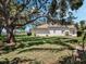 Expansive backyard with mature trees, lush lawn, and well-maintained landscaping at 5906 Prince Philip Ct, Leesburg, FL 34748