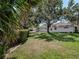 Spacious backyard with mature trees and lush green lawn at 5906 Prince Philip Ct, Leesburg, FL 34748