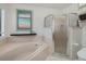 Bathroom features a soaking tub, glass enclosed shower, and a unique tile pattern at 5906 Prince Philip Ct, Leesburg, FL 34748