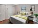 Cozy bedroom with white bedding, side tables, and a window offering natural light at 5906 Prince Philip Ct, Leesburg, FL 34748