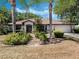 Well-maintained single-story home with a lush front yard featuring decorative rock landscaping and palm trees at 5906 Prince Philip Ct, Leesburg, FL 34748