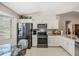 Modern kitchen featuring stainless steel appliances, granite countertops, and a cozy breakfast nook at 5906 Prince Philip Ct, Leesburg, FL 34748