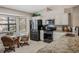 Bright kitchen with stainless steel appliances, granite countertops, and a cozy breakfast area at 5906 Prince Philip Ct, Leesburg, FL 34748