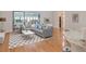 Bright living room features a comfortable sectional, stylish rug, and sliding glass doors to an outdoor patio at 5906 Prince Philip Ct, Leesburg, FL 34748