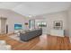 Bright living room featuring vaulted ceilings, hardwood floors, and sliding glass doors leading to the lanai at 5906 Prince Philip Ct, Leesburg, FL 34748