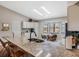 Bright living room with vaulted ceiling, hardwood floors, and a sliding glass door to the outside at 5906 Prince Philip Ct, Leesburg, FL 34748