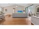Bright living room with hardwood floors, high ceilings, and sliding glass doors to the outdoors at 5906 Prince Philip Ct, Leesburg, FL 34748