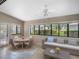 Bright sunroom featuring a dining table and sitting area, and large windows at 5906 Prince Philip Ct, Leesburg, FL 34748