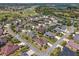 Beautiful aerial view of a neighborhood with lush landscaping, golf course, and community lake at 630 Laurel Run, The Villages, FL 32162
