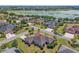 Aerial view of a home within a neighborhood with palm trees and manicured lawns at 630 Laurel Run, The Villages, FL 32162