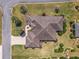 Aerial shot of the home showcasing its roof, landscaping, and surrounding greenery at 630 Laurel Run, The Villages, FL 32162