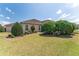 Well-maintained backyard with lush landscaping, green lawn, and mature shrubbery at 630 Laurel Run, The Villages, FL 32162