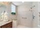 Shower area with multiple shower heads, safety bar and tile accent border at 630 Laurel Run, The Villages, FL 32162