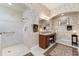 Detailed bathroom featuring a spacious walk-in shower and granite countertop vanity at 630 Laurel Run, The Villages, FL 32162