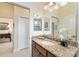 Bathroom vanity with granite countertops and views to other rooms at 630 Laurel Run, The Villages, FL 32162