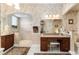 Spacious bathroom with custom cabinets, granite counters, a makeup table and walk-in shower at 630 Laurel Run, The Villages, FL 32162