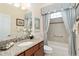 Bright bathroom with granite countertops and a tub/shower combo at 630 Laurel Run, The Villages, FL 32162