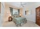 Bedroom with ceiling fan, large window and dresser with mirror at 630 Laurel Run, The Villages, FL 32162