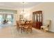 Open dining area with wood floors, chandelier, access to lanai, and beautiful wood furniture at 630 Laurel Run, The Villages, FL 32162
