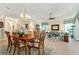 Dining room featuring a dining table and chairs, chandelier, and is open to the living area at 630 Laurel Run, The Villages, FL 32162