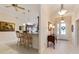 Lovely view from breakfast bar to entryway with a decorative front door and transom window at 630 Laurel Run, The Villages, FL 32162
