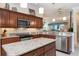 Well-equipped kitchen featuring granite counters, stainless appliances and eat-in breakfast bar at 630 Laurel Run, The Villages, FL 32162