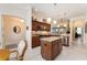 Modern kitchen with stainless appliances, granite countertops, and central island with eat-in breakfast bar at 630 Laurel Run, The Villages, FL 32162