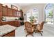 Eat-in kitchen dining area with custom cabinets, granite counters and large arched window at 630 Laurel Run, The Villages, FL 32162