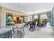 The lanai features an outdoor dining area, seating, and sliding glass doors to the home's interior at 630 Laurel Run, The Villages, FL 32162