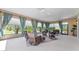 Spacious screened lanai with multiple seating areas and views of the lush landscaping at 630 Laurel Run, The Villages, FL 32162