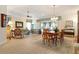 Spacious and bright open-concept living and dining area with wood floors and elegant furnishings at 630 Laurel Run, The Villages, FL 32162