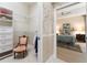 Walk-in closet leads to a main bedroom with hardwood floors and ceiling fan at 630 Laurel Run, The Villages, FL 32162