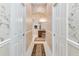 Walk-in closet between the main bedroom and ensuite bathroom features custom wall paper at 630 Laurel Run, The Villages, FL 32162