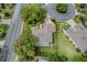 Aerial view of a single-Gathering home showcasing the roof and surrounding landscaped yard with mature trees at 725 Beldon Ct, The Villages, FL 32162