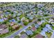 An aerial view showcasing a home within a well-maintained neighborhood with mature trees and green spaces at 725 Beldon Ct, The Villages, FL 32162