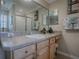 Bathroom with a light wood vanity, a framed mirror, and decoratively themed wall art at 725 Beldon Ct, The Villages, FL 32162