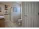 Cozy bathroom featuring tiled floors, a glass enclosed shower, and natural lighting at 725 Beldon Ct, The Villages, FL 32162