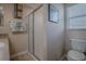 Cozy bathroom featuring tiled floors, a glass enclosed shower, and natural lighting at 725 Beldon Ct, The Villages, FL 32162