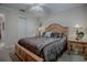 Comfortable bedroom featuring a decorative headboard and neutral walls at 725 Beldon Ct, The Villages, FL 32162