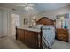 Comfortable bedroom with a wooden bed frame, soft carpet, and side tables at 725 Beldon Ct, The Villages, FL 32162