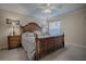 Comfortable bedroom with a wooden bed frame, soft carpet, and side tables at 725 Beldon Ct, The Villages, FL 32162