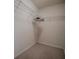Carpeted walk-in closet with wire shelving and visible wall stains at 725 Beldon Ct, The Villages, FL 32162