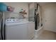 Fully equipped laundry room with modern appliances and plenty of storage space at 725 Beldon Ct, The Villages, FL 32162