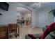 Comfortable living room showcasing an arched doorway into the dining room and kitchen areas at 725 Beldon Ct, The Villages, FL 32162