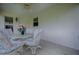 Cozy screened patio with stylish wicker furniture and plenty of natural light at 725 Beldon Ct, The Villages, FL 32162
