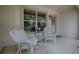 Charming front porch with comfortable wicker seating, decorative door, and pleasant natural light at 725 Beldon Ct, The Villages, FL 32162