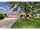 Charming single-story home with a three-car garage, manicured lawn, and mature landscaping at 725 Beldon Ct, The Villages, FL 32162