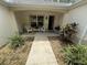 Charming front porch with seating area and beautiful landscaping at 725 Beldon Ct, The Villages, FL 32162