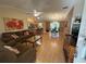 Open living room featuring hardwood floors, ceiling fan, and access to the kitchen and dining area at 725 Beldon Ct, The Villages, FL 32162