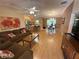 Comfortable living room with wood laminate flooring and open to the kitchen and dining room at 725 Beldon Ct, The Villages, FL 32162